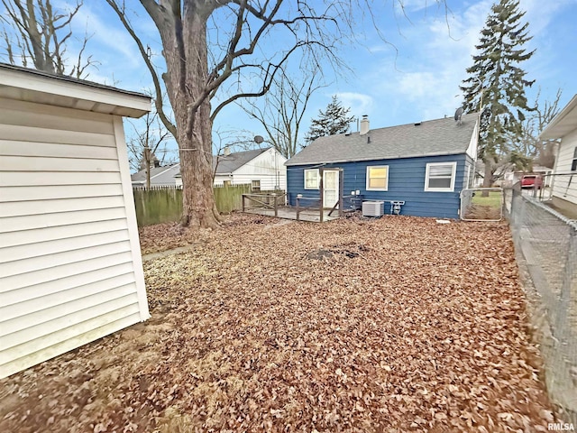 back of house with central AC unit