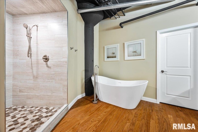 bathroom featuring wood-type flooring and shower with separate bathtub