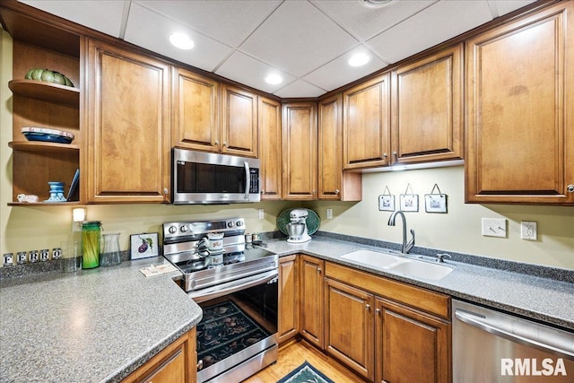 316 SW Washington St Unit 603, Peoria, IL 61602 - kitchen with appliances with stainless steel finishes, a sink, open shelves, brown cabinets, and recessed lighting
