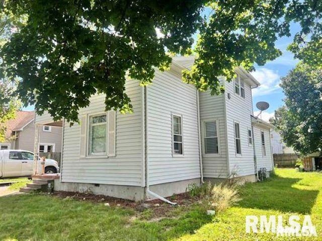 view of side of property with a lawn