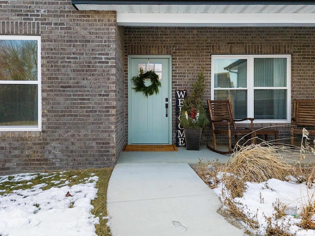 view of snow covered property entrance