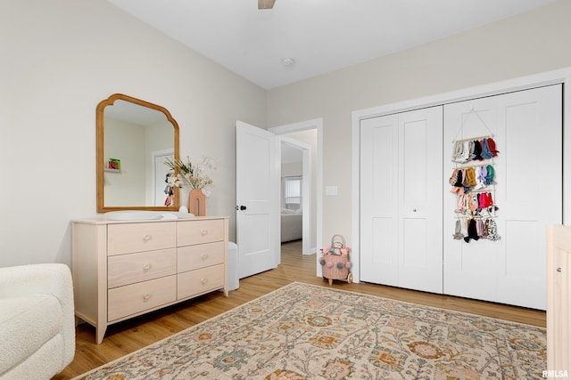 bedroom with ceiling fan, a closet, and light wood-type flooring