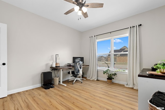 office with light hardwood / wood-style flooring and ceiling fan