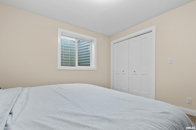 carpeted bedroom with a closet