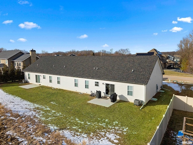 snow covered house with a yard, central AC unit, and a patio area