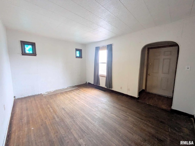 empty room with dark wood-type flooring