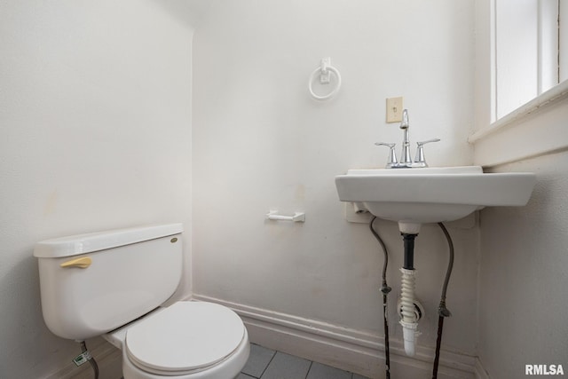 bathroom with toilet and tile patterned flooring