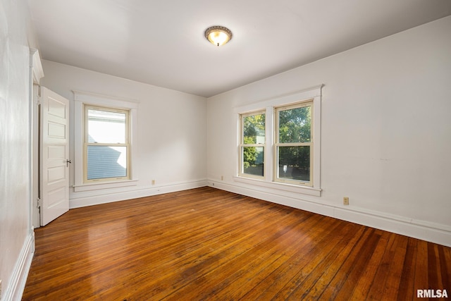 spare room featuring dark hardwood / wood-style floors