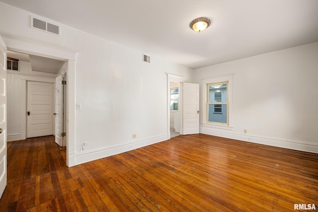 spare room featuring dark hardwood / wood-style floors