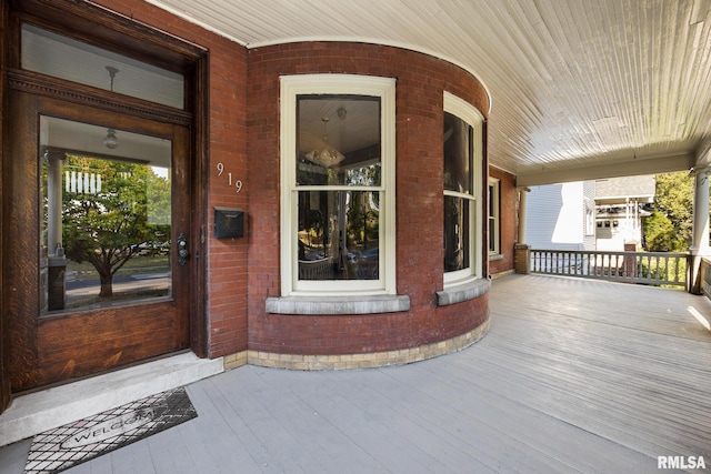 view of exterior entry with a porch