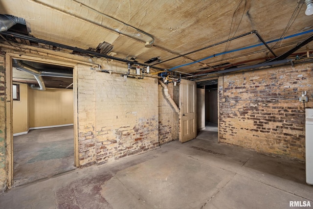 basement featuring brick wall