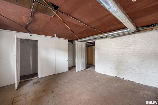 basement with brick wall