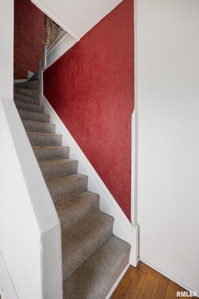 stairs featuring hardwood / wood-style flooring