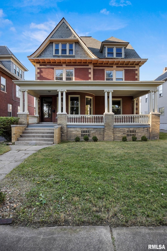 view of front facade with a front lawn and a porch