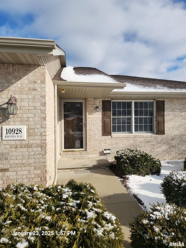 view of snow covered property entrance