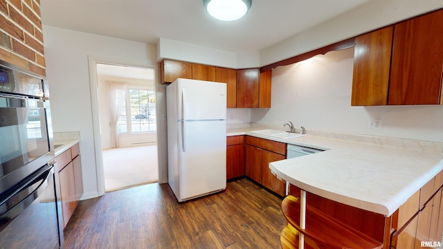 kitchen featuring sink, dark hardwood / wood-style floors, oven, and white refrigerator