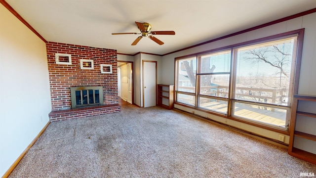 unfurnished living room with a fireplace, ornamental molding, ceiling fan, and carpet