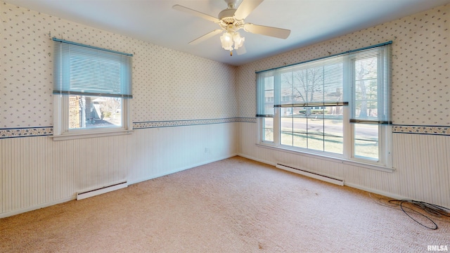 unfurnished room with a healthy amount of sunlight, a baseboard heating unit, and light carpet