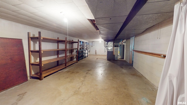 basement featuring heating unit and water heater