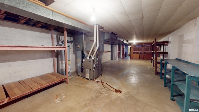 basement featuring heating unit and water heater