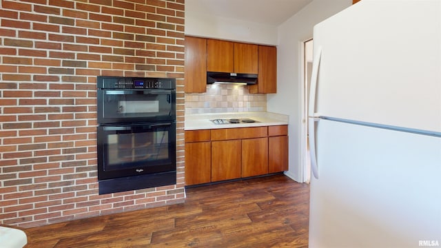 kitchen featuring white appliances, dark hardwood / wood-style floors, and backsplash