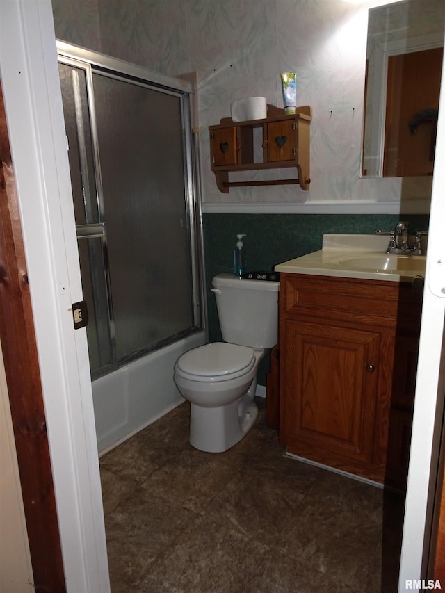 full bathroom featuring vanity, bath / shower combo with glass door, and toilet