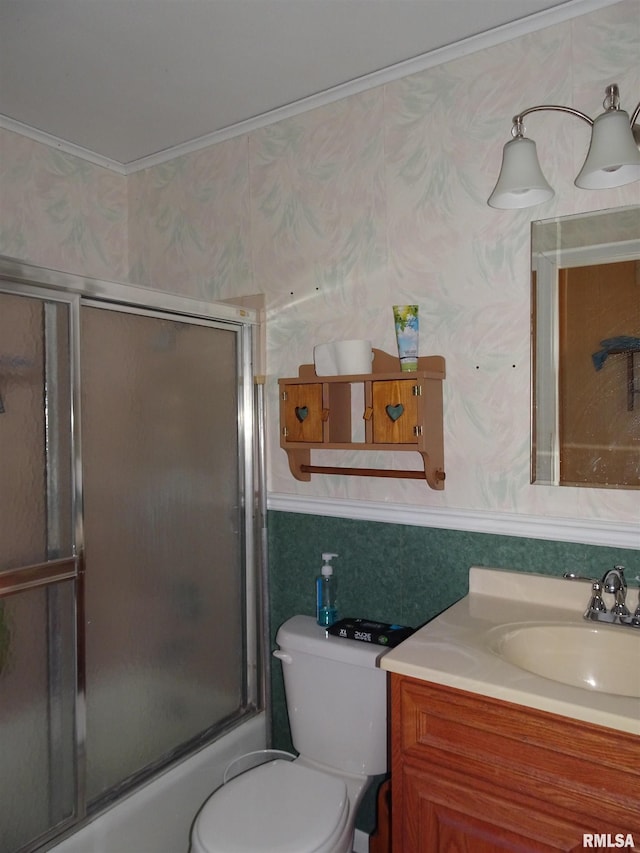 full bathroom with toilet, ornamental molding, vanity, and shower / bath combination with glass door