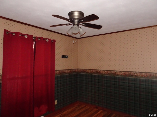 spare room featuring ornamental molding and dark hardwood / wood-style floors