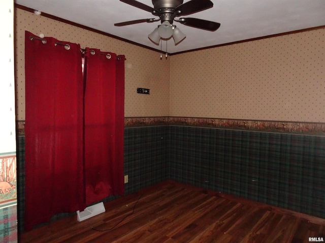 empty room with crown molding, ceiling fan, and dark hardwood / wood-style floors