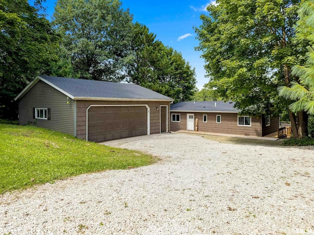 view of front of property with a garage and a front lawn