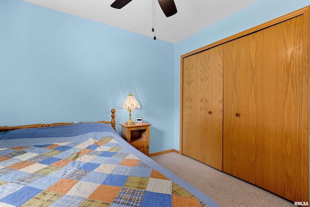 unfurnished bedroom with light colored carpet, a textured ceiling, ceiling fan, and a closet