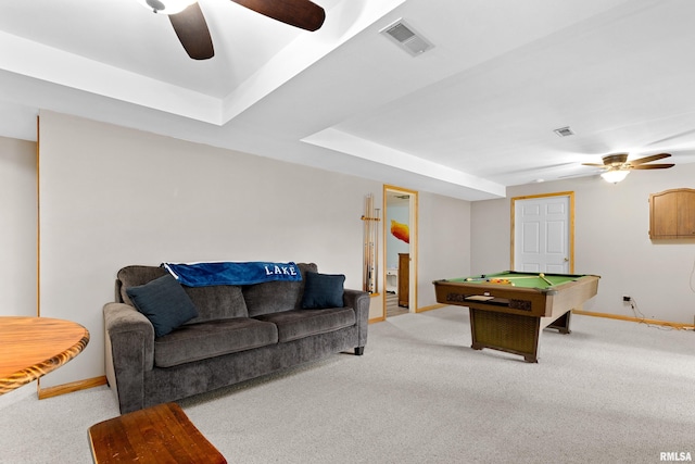 rec room with a tray ceiling, pool table, light colored carpet, and ceiling fan