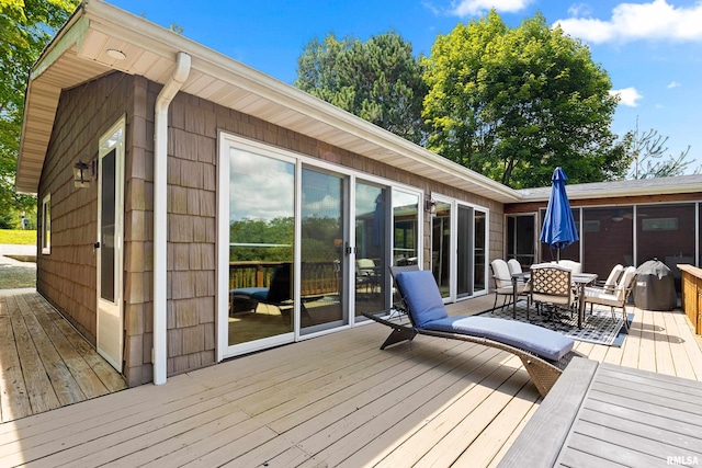 wooden deck featuring a sunroom