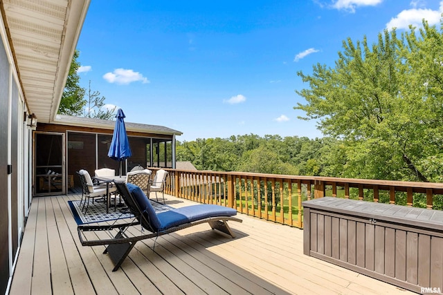 wooden deck with a sunroom