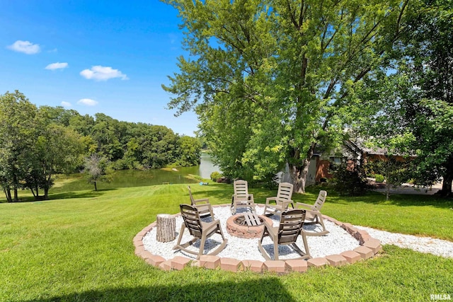 view of yard with a water view and an outdoor fire pit