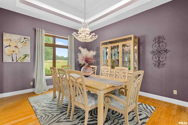 dining room with an inviting chandelier and wood-type flooring