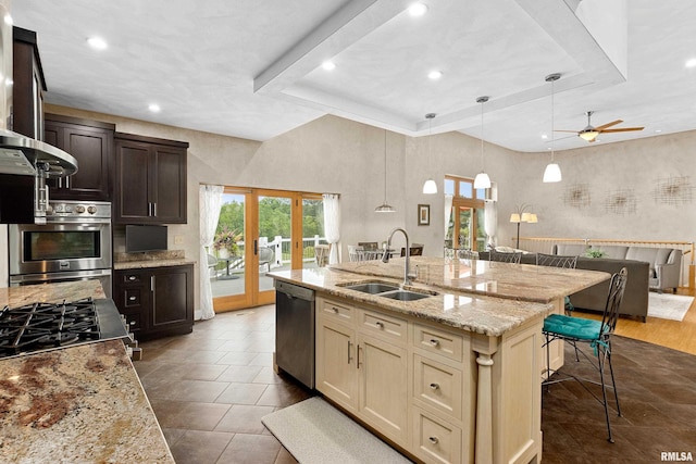 kitchen featuring appliances with stainless steel finishes, french doors, sink, dark brown cabinetry, and cream cabinetry