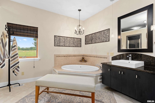 bathroom with vanity, a bath, a chandelier, and tile patterned flooring