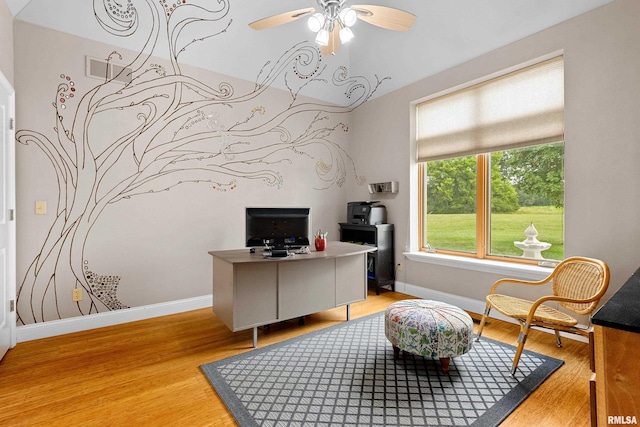 office with ceiling fan and light hardwood / wood-style flooring