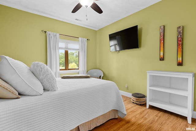 bedroom with hardwood / wood-style floors and ceiling fan