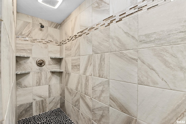 bathroom with a tile shower