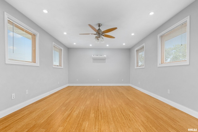 empty room with ceiling fan and light hardwood / wood-style floors