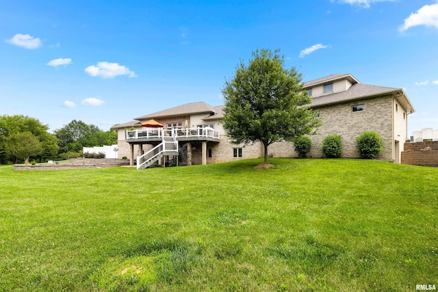 back of property featuring a wooden deck and a yard