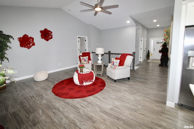 living area featuring hardwood / wood-style flooring, high vaulted ceiling, and ceiling fan