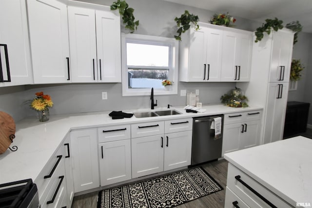 kitchen with sink, white cabinets, dark hardwood / wood-style flooring, stainless steel dishwasher, and range