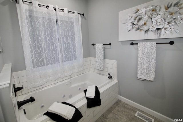 bathroom with tiled tub