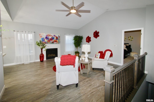 living room featuring vaulted ceiling, hardwood / wood-style floors, and ceiling fan