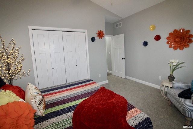 bedroom with carpet floors, vaulted ceiling, and a closet