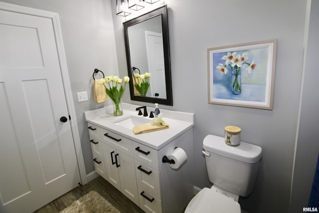 bathroom featuring hardwood / wood-style flooring, vanity, and toilet