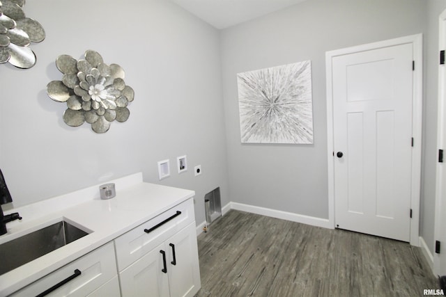 laundry area featuring sink, dark wood-type flooring, electric dryer hookup, cabinets, and washer hookup